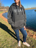 woman in pray black leopard sweatshirt with cross on arm