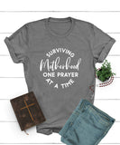 Surviving Motherhood One Prayer At a Time Tee