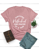 Surviving Motherhood One Prayer At a Time Tee